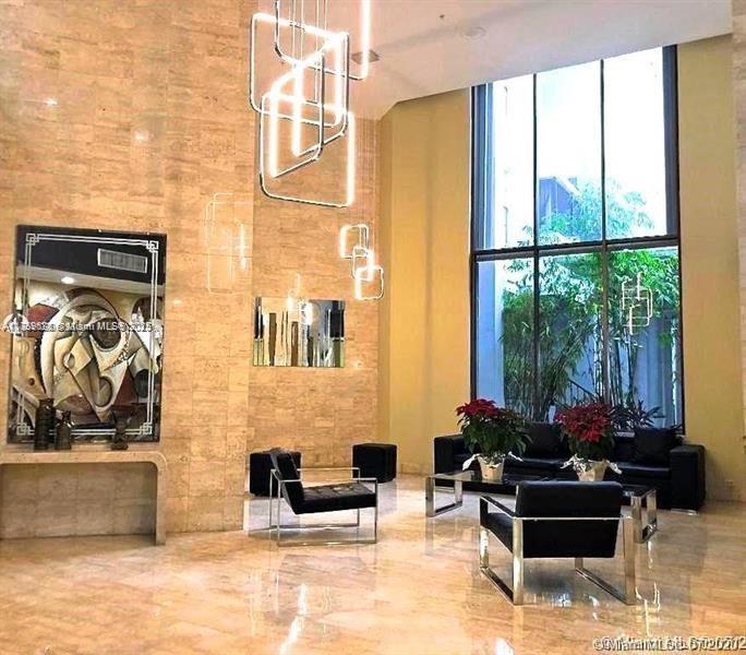 2750 Northeast 183rd Street, Unit 1701 Aventura, FL 33160 - Photo 14 of 40 a living room with furniture and a floor to ceiling window