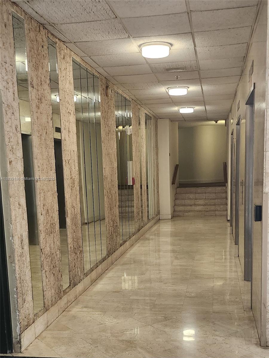 2750 Northeast 183rd Street, Unit 1701 Aventura, FL 33160 - Photo 19 of 40 a view of hallway with a glass door shower