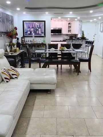 a kitchen with stainless steel appliances kitchen island granite countertop a table and chairs in it