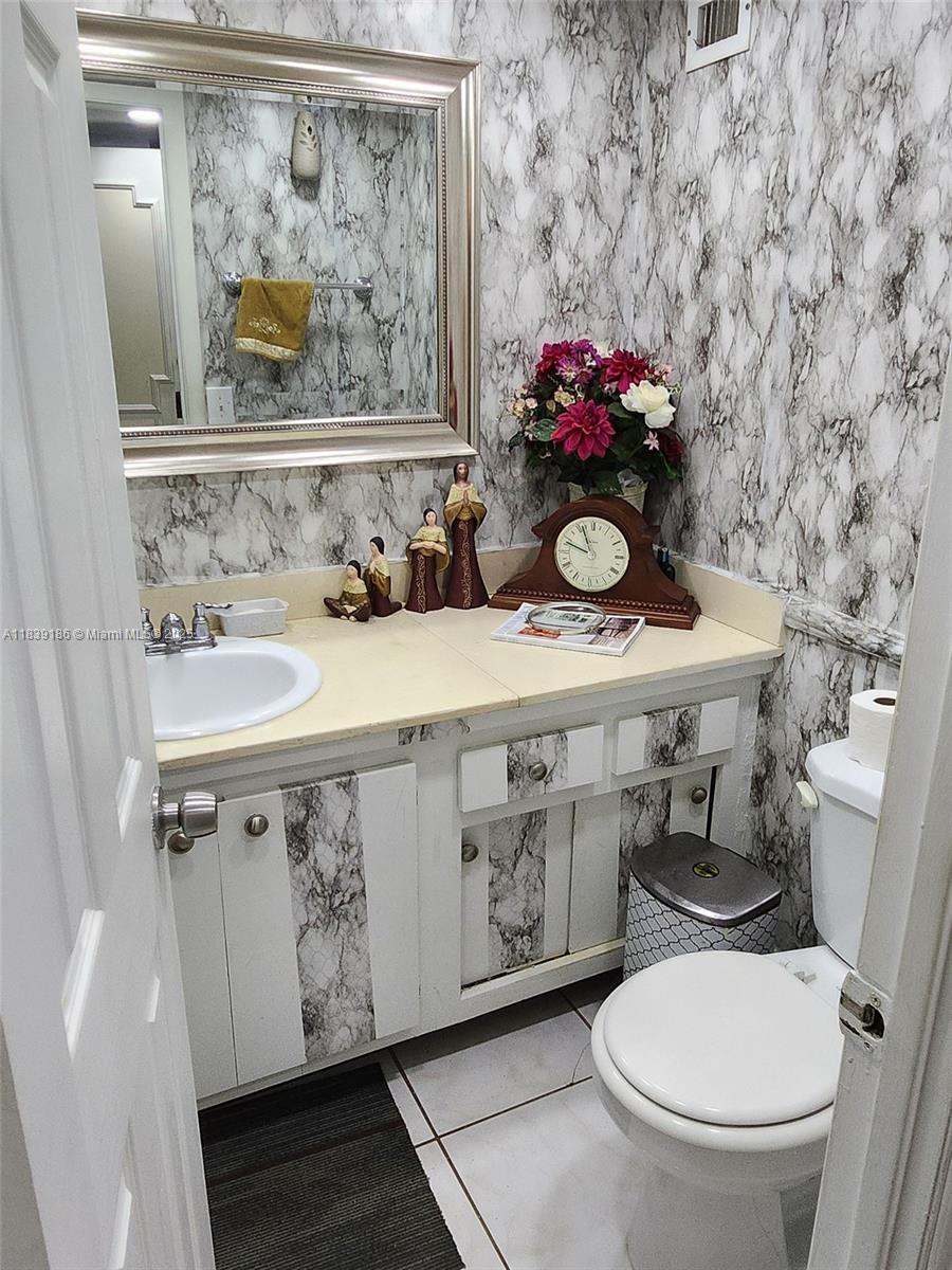 2750 Northeast 183rd Street, Unit 1701 Aventura, FL 33160 - Photo 10 of 40 a bathroom with a toilet sink and mirror
