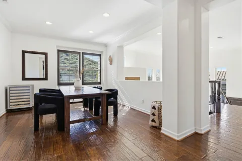 a view of a a dining room with furniture window and wooden floor