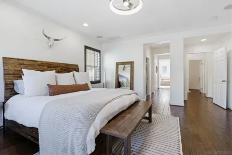 a bedroom with a bed and wooden floor