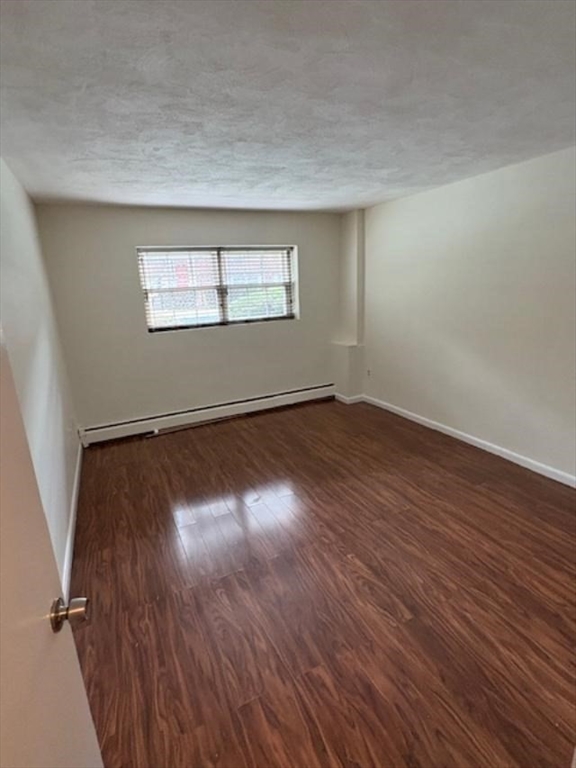 15 Cass Street, Unit 3 Boston, MA 02132 - Photo 12 of 24 an empty room with wooden floor and windows
