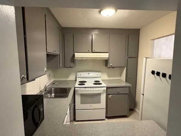 a kitchen with a stove and a refrigerator