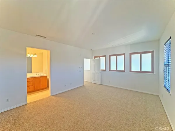 a bathroom with a tub a sink and a mirror