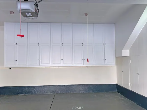 a view of backyard with swimming pool and seating space