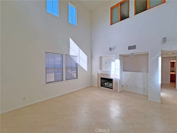 a view of a livingroom with a fireplace and window
