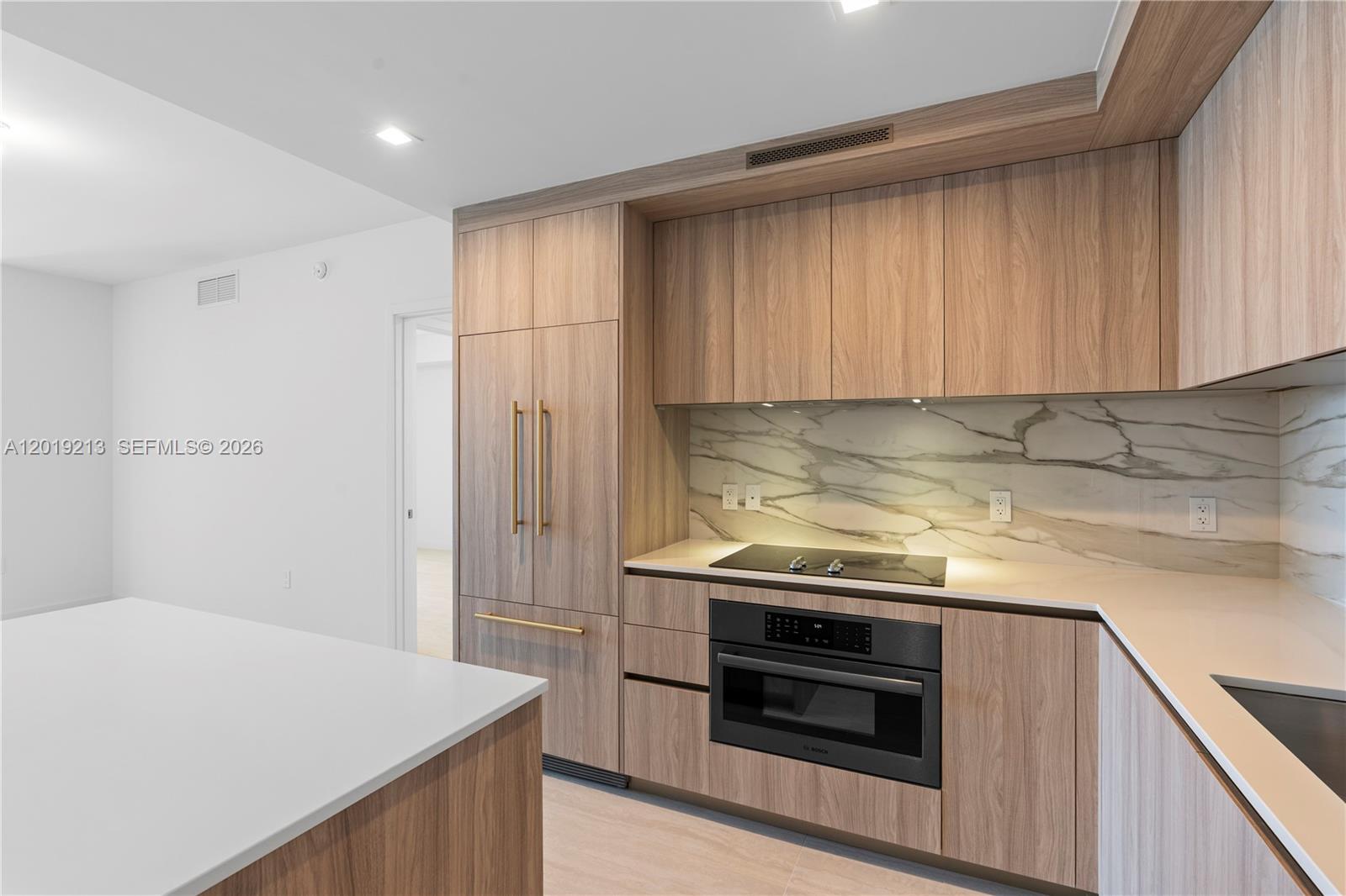 77 Southeast 5th, Unit 3702 Miami, FL 33131 - Photo 4 of 63 a kitchen with a stove and a refrigerator