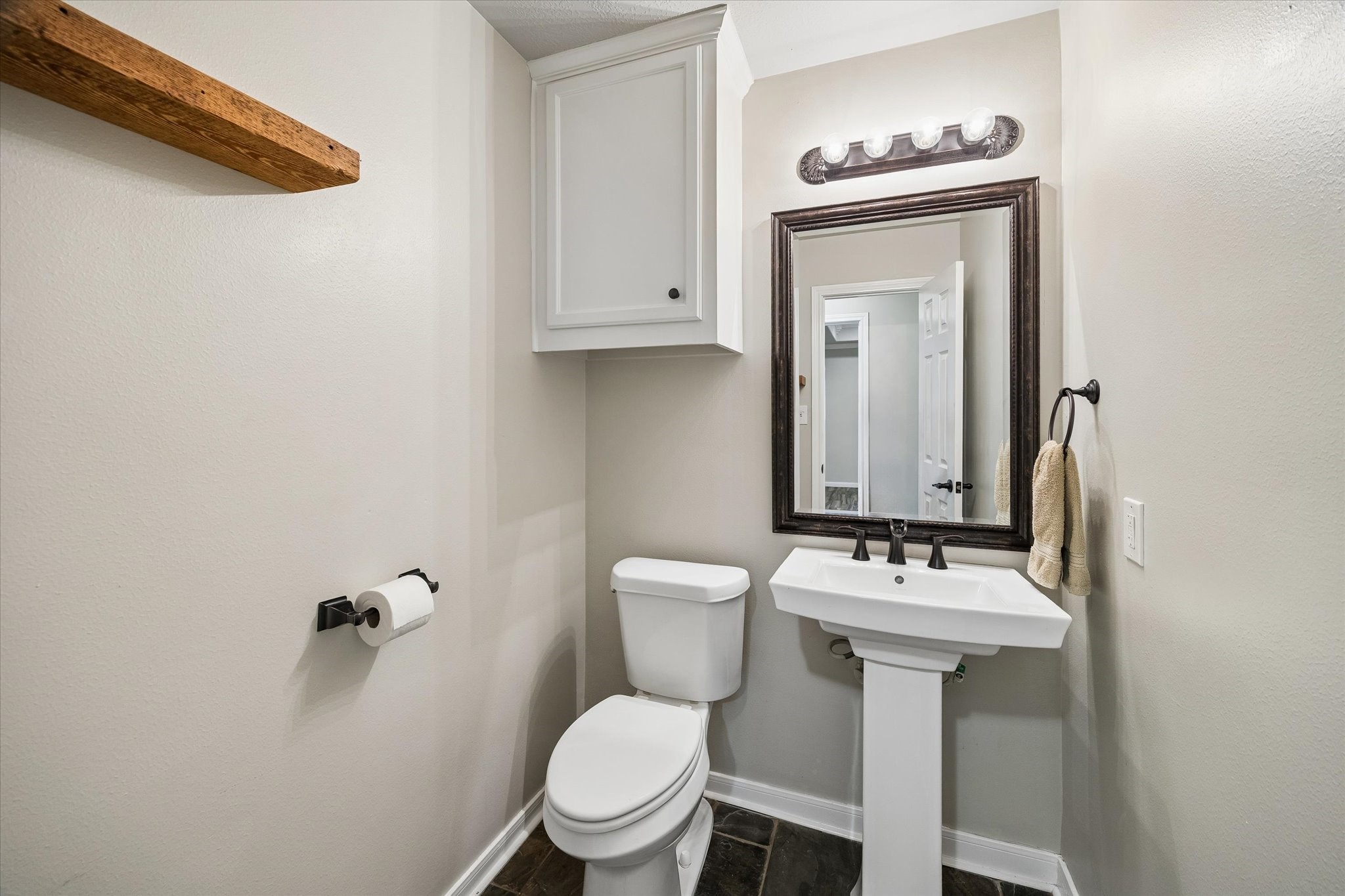 109 Dawns Edge Conroe, TX 77356 - Photo 17 of 24 a bathroom with a toilet a sink and mirror