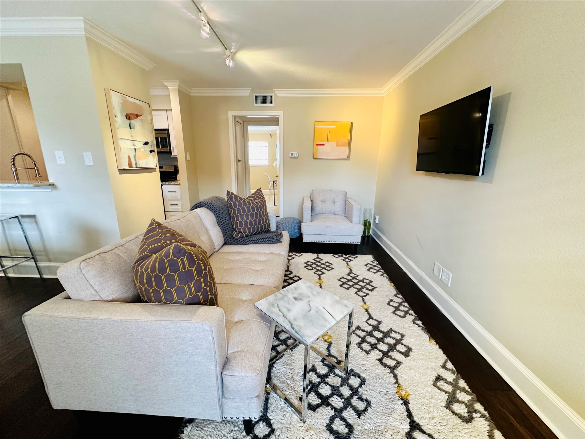 3402 Garrott Street, Unit 16 Houston, TX 77006 - Photo 1 of 47 a living room with furniture and a flat screen tv