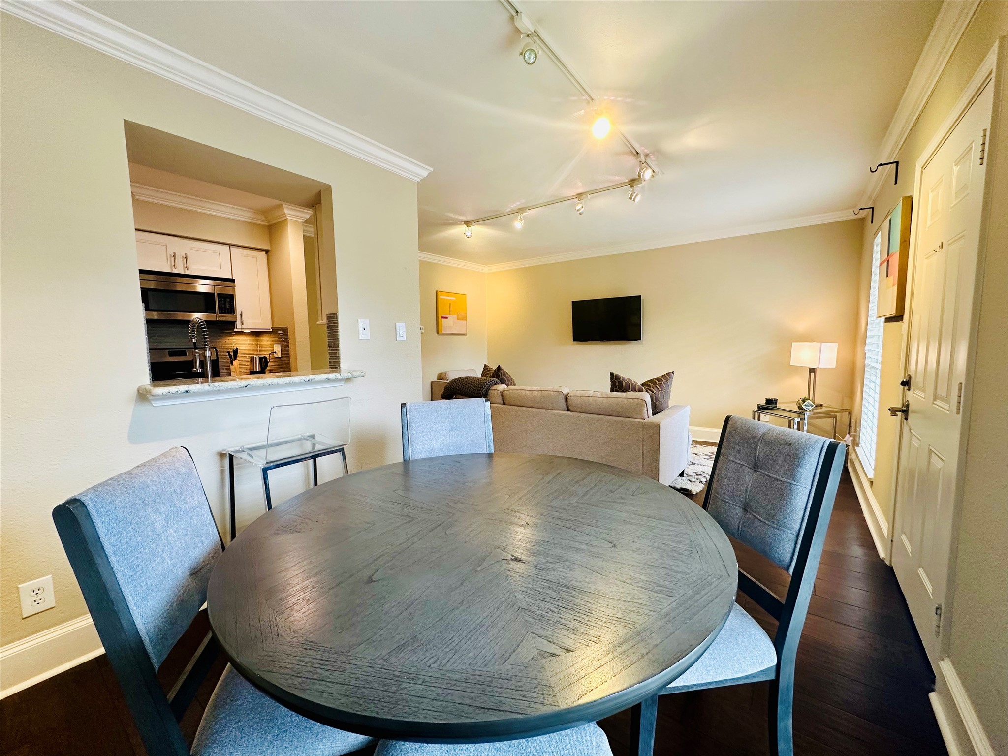 3402 Garrott Street, Unit 16 Houston, TX 77006 - Photo 13 of 47 a view of a dining room with furniture and wooden floor