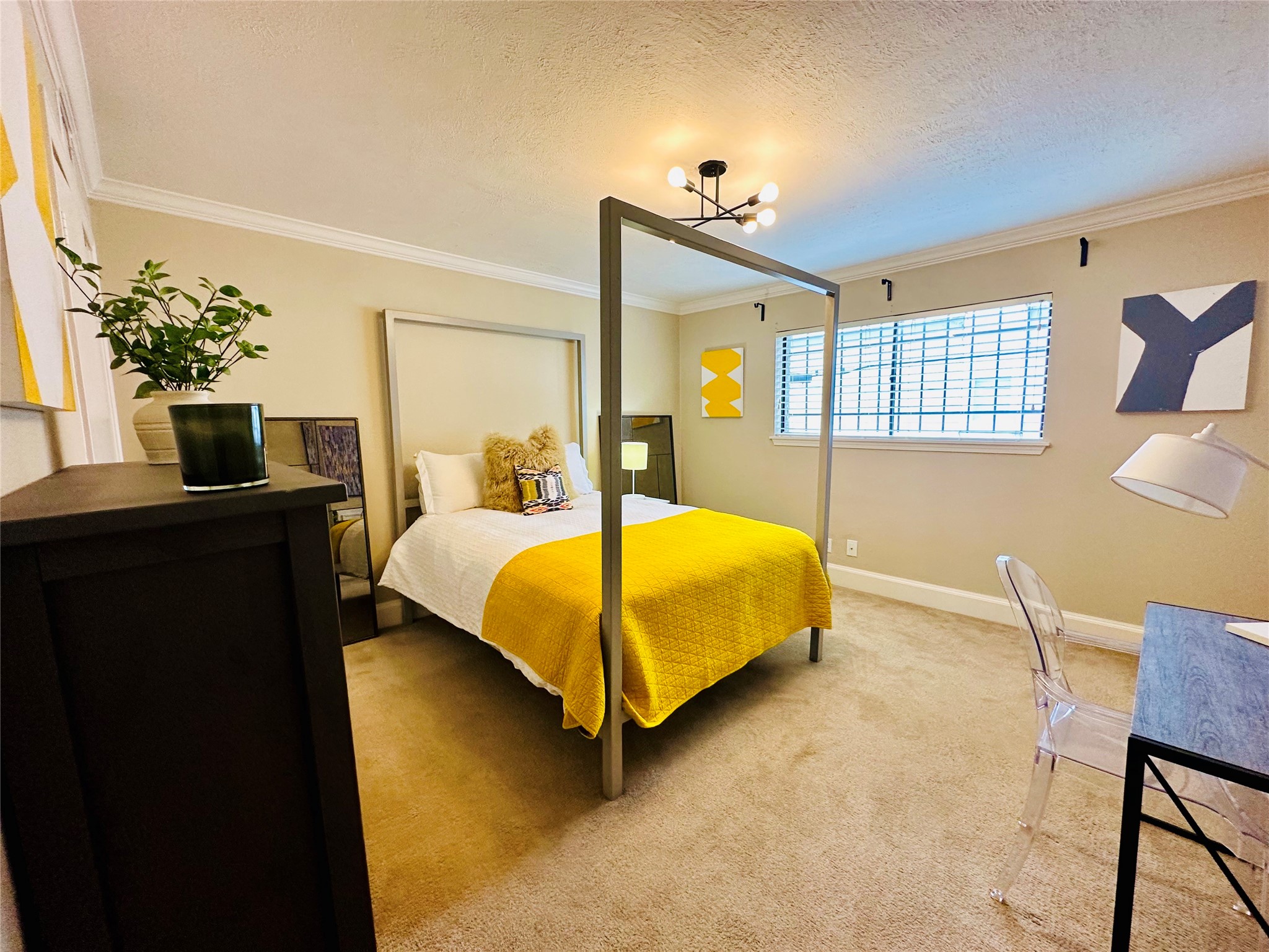 3402 Garrott Street, Unit 16 Houston, TX 77006 - Photo 15 of 47 a bedroom with a bed table and chair
