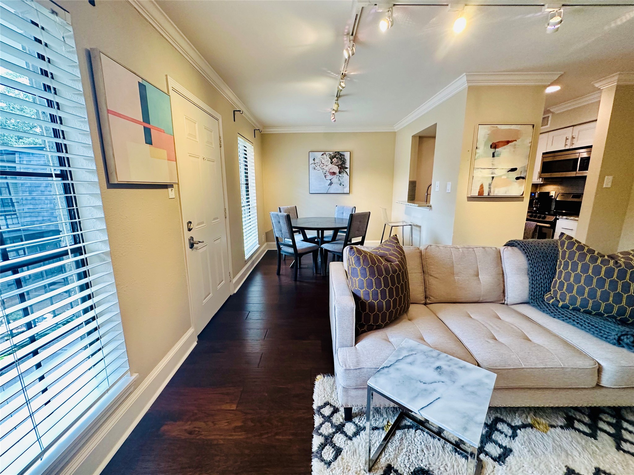 3402 Garrott Street, Unit 16 Houston, TX 77006 - Photo 26 of 47 a living room with furniture wooden floor and a chandelier