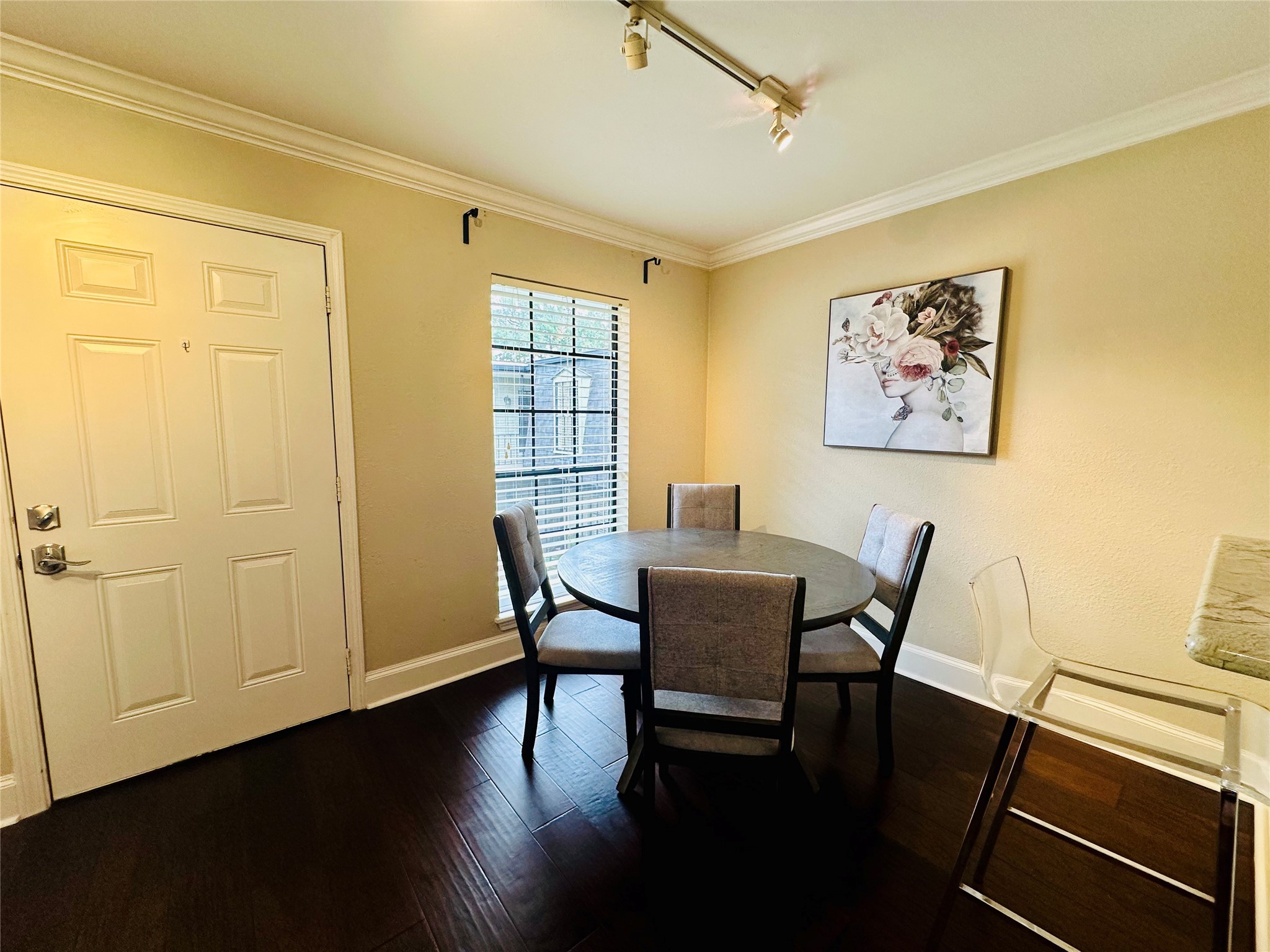 3402 Garrott Street, Unit 16 Houston, TX 77006 - Photo 28 of 47 a view of a dining room with furniture and wooden floor