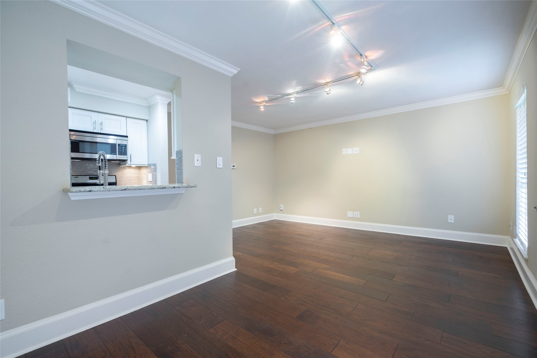 3402 Garrott Street, Unit 16 Houston, TX 77006 - Photo 36 of 47 an empty room with wooden floor and windows
