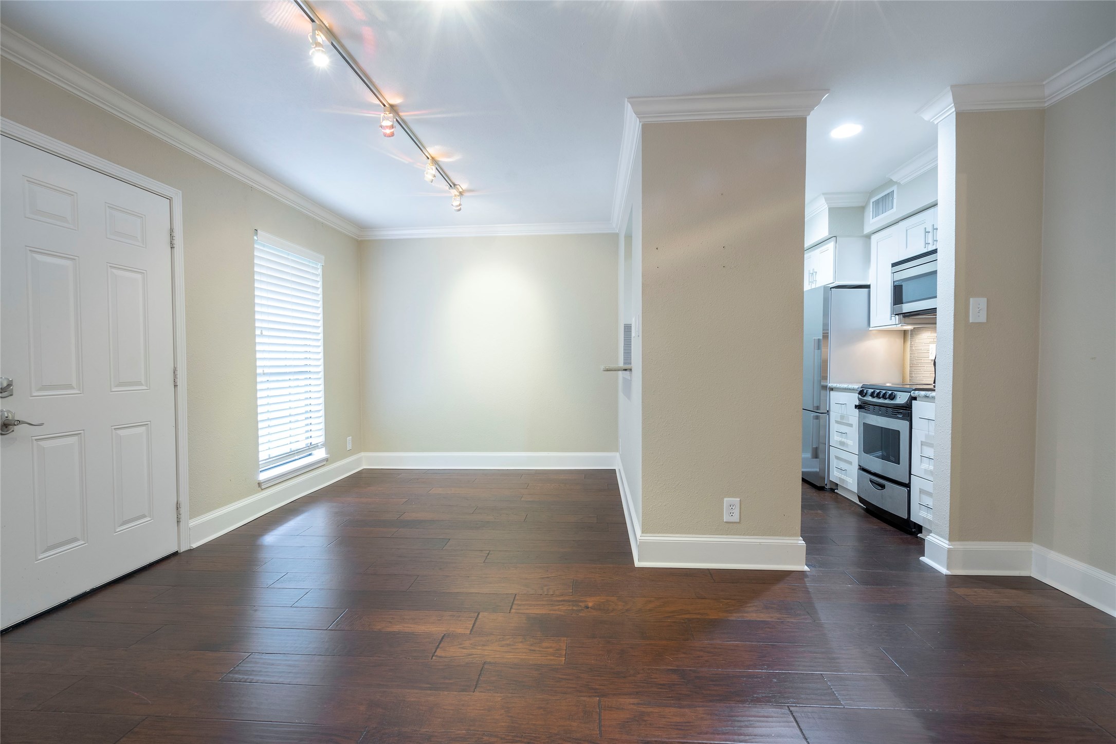 3402 Garrott Street, Unit 16 Houston, TX 77006 - Photo 37 of 47 an empty room with wooden floor and windows