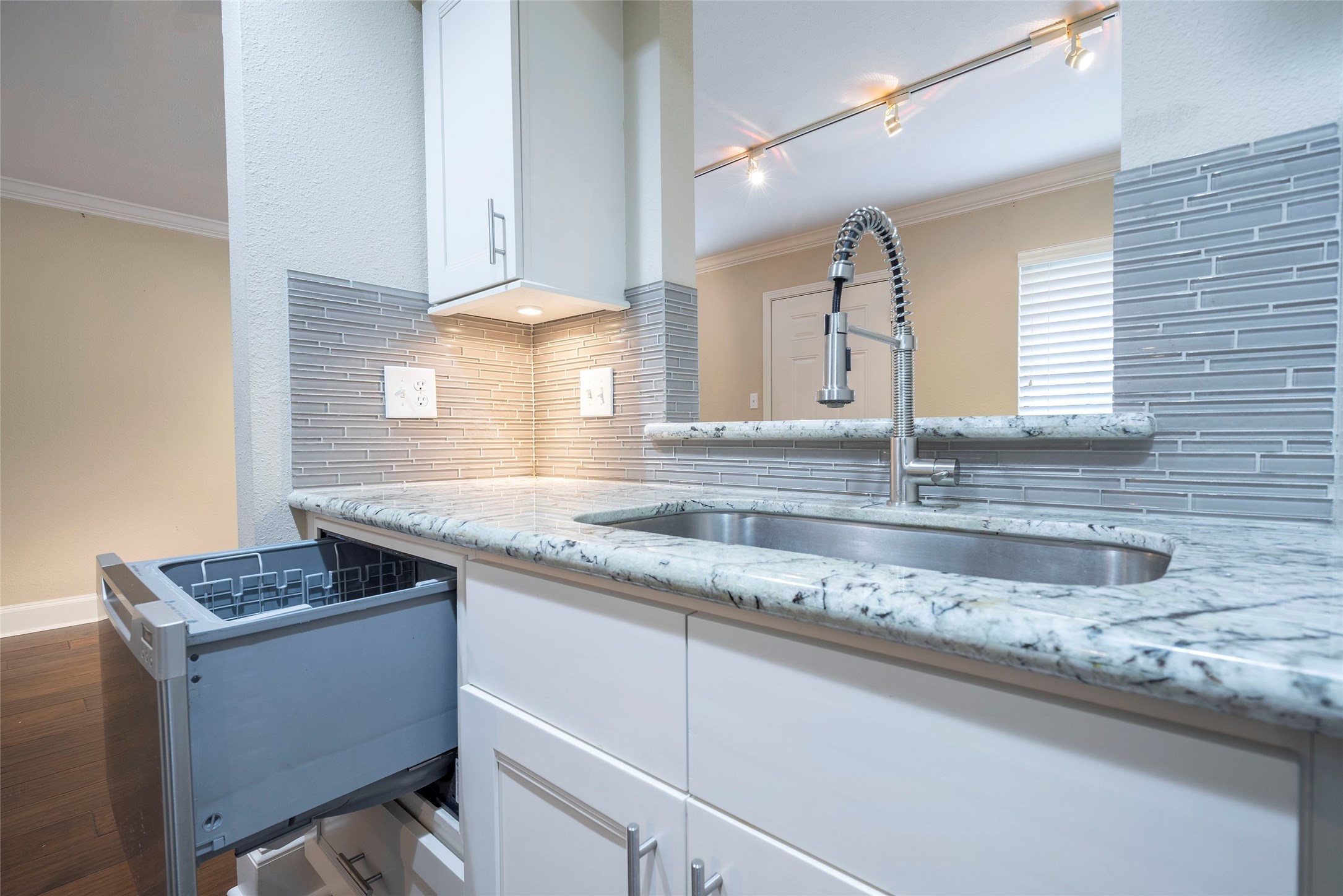 3402 Garrott Street, Unit 16 Houston, TX 77006 - Photo 39 of 47 a kitchen with granite countertop white cabinets and a sink