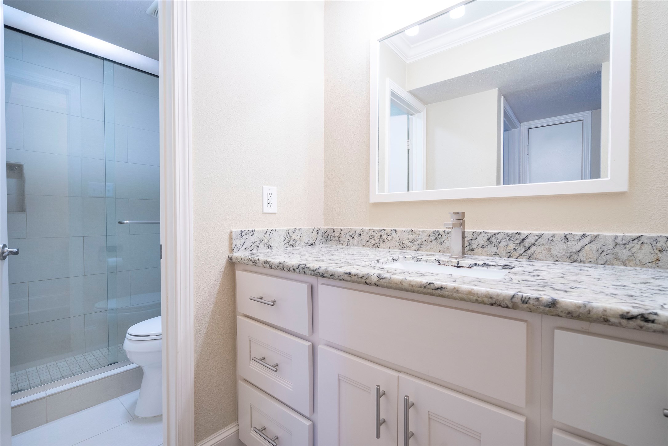 3402 Garrott Street, Unit 16 Houston, TX 77006 - Photo 40 of 47 a bathroom with a granite countertop sink and a mirror