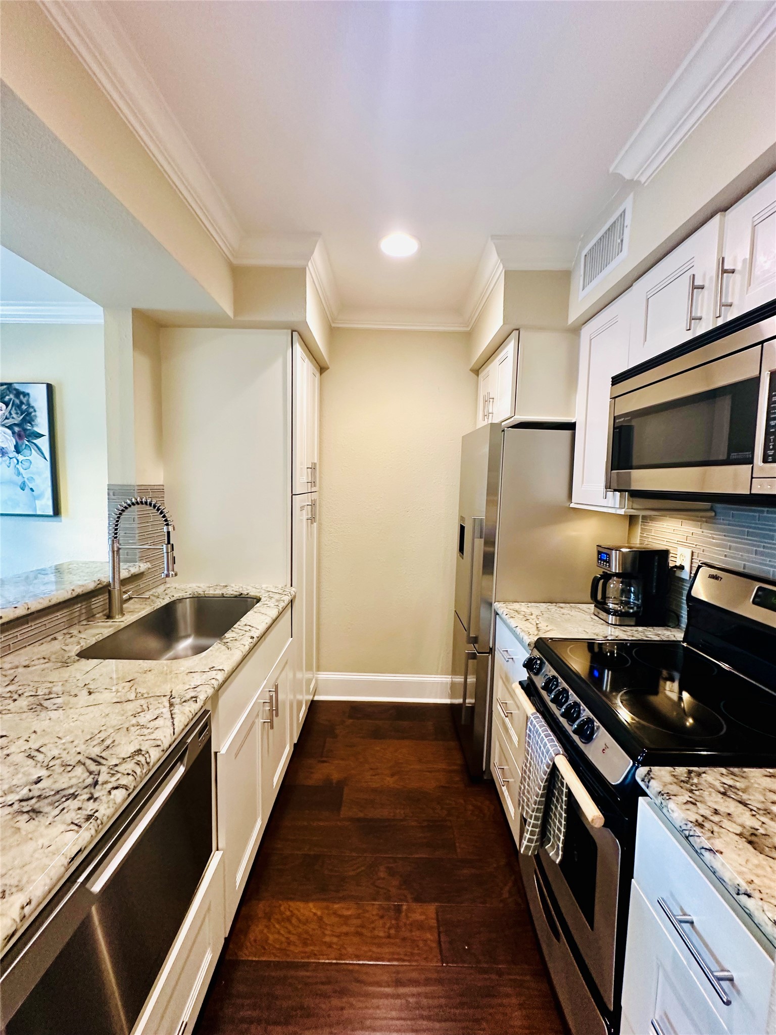 3402 Garrott Street, Unit 16 Houston, TX 77006 - Photo 6 of 47 a kitchen with stainless steel appliances granite countertop a sink stove and refrigerator