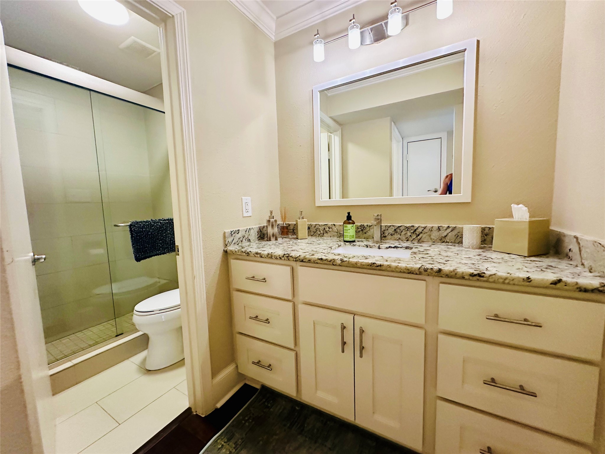 3402 Garrott Street, Unit 16 Houston, TX 77006 - Photo 8 of 47 a bathroom with a granite countertop sink toilet and shower