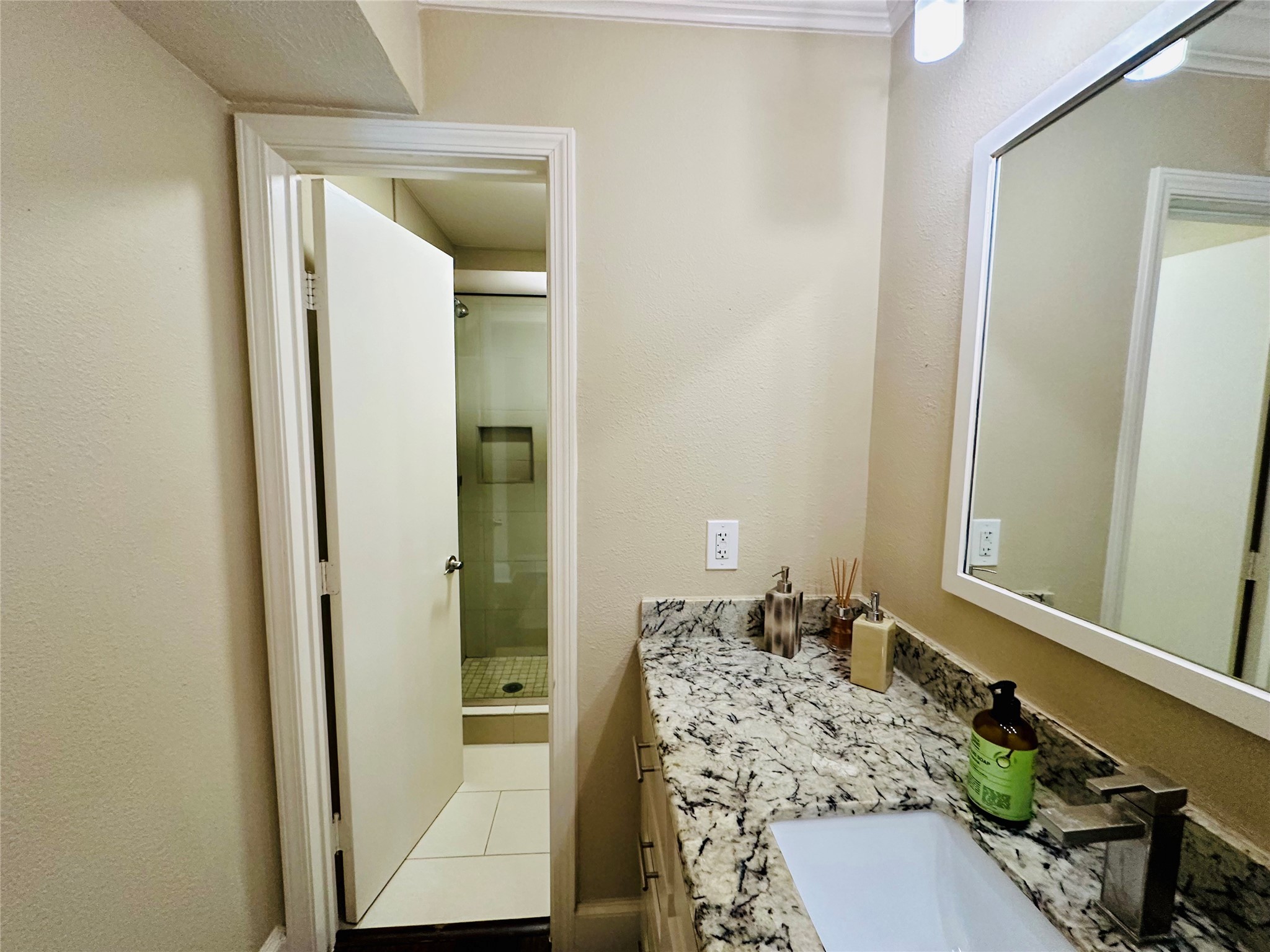 3402 Garrott Street, Unit 16 Houston, TX 77006 - Photo 9 of 47 a bathroom with a granite countertop sink and a mirror