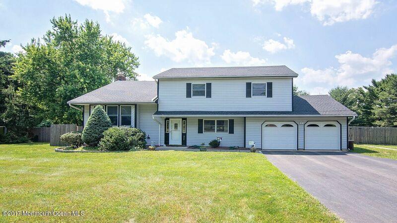 800 Waterworks Road Freehold, NJ 07728 - Photo 1 of 28 a front view of a house with a garden