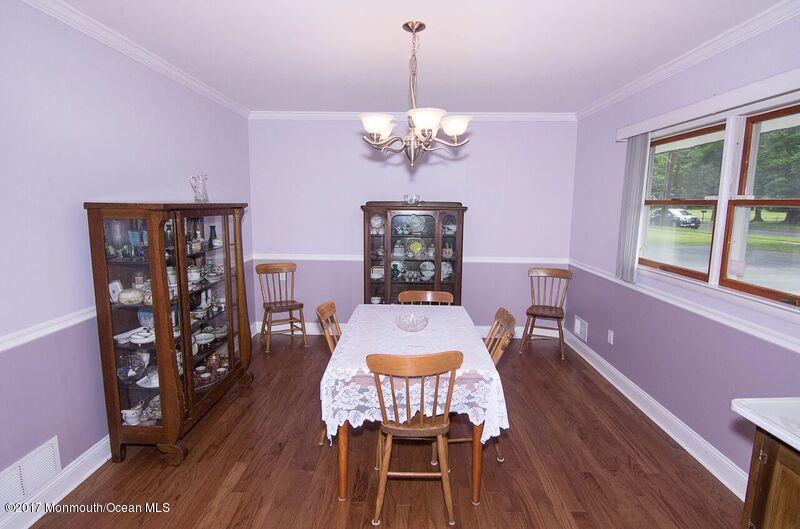 800 Waterworks Road Freehold, NJ 07728 - Photo 13 of 28 a dining room with furniture a chandelier and wooden floor