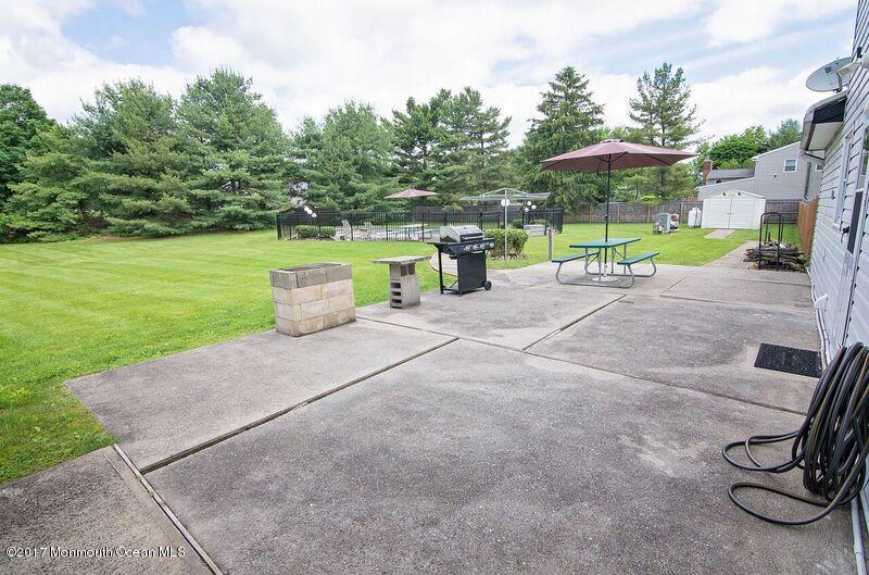 800 Waterworks Road Freehold, NJ 07728 - Photo 26 of 28 a view of a patio with a table and chairs under an umbrella