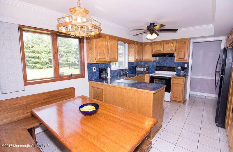 800 Waterworks Road Freehold, NJ 07728 - Photo 8 of 28 a kitchen with stainless steel appliances granite countertop a stove a sink dishwasher and a stove with the view of living room