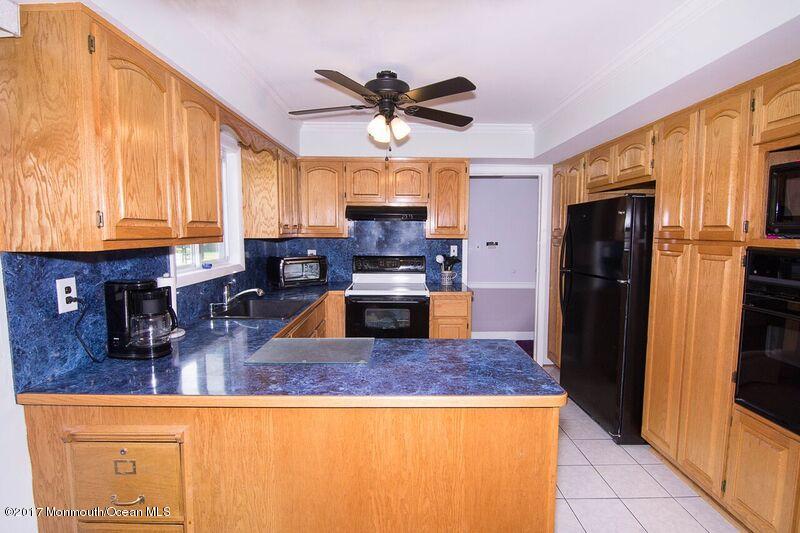 800 Waterworks Road Freehold, NJ 07728 - Photo 9 of 28 a kitchen with stainless steel appliances granite countertop a refrigerator a stove and a sink with large window