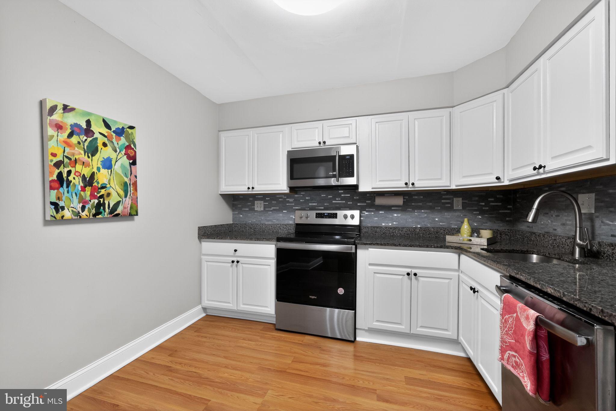 400 Glendale Road, Unit F35 Havertown, PA 19083 - Photo 15 of 36 a kitchen with stainless steel appliances granite countertop a stove and a microwave