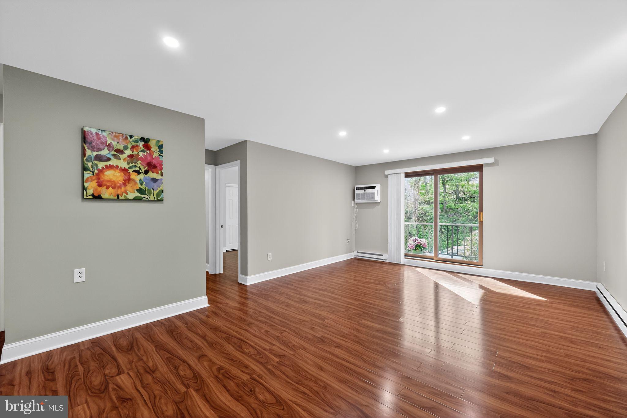 400 Glendale Road, Unit F35 Havertown, PA 19083 - Photo 5 of 36 a view of an empty room with wooden floor and a window