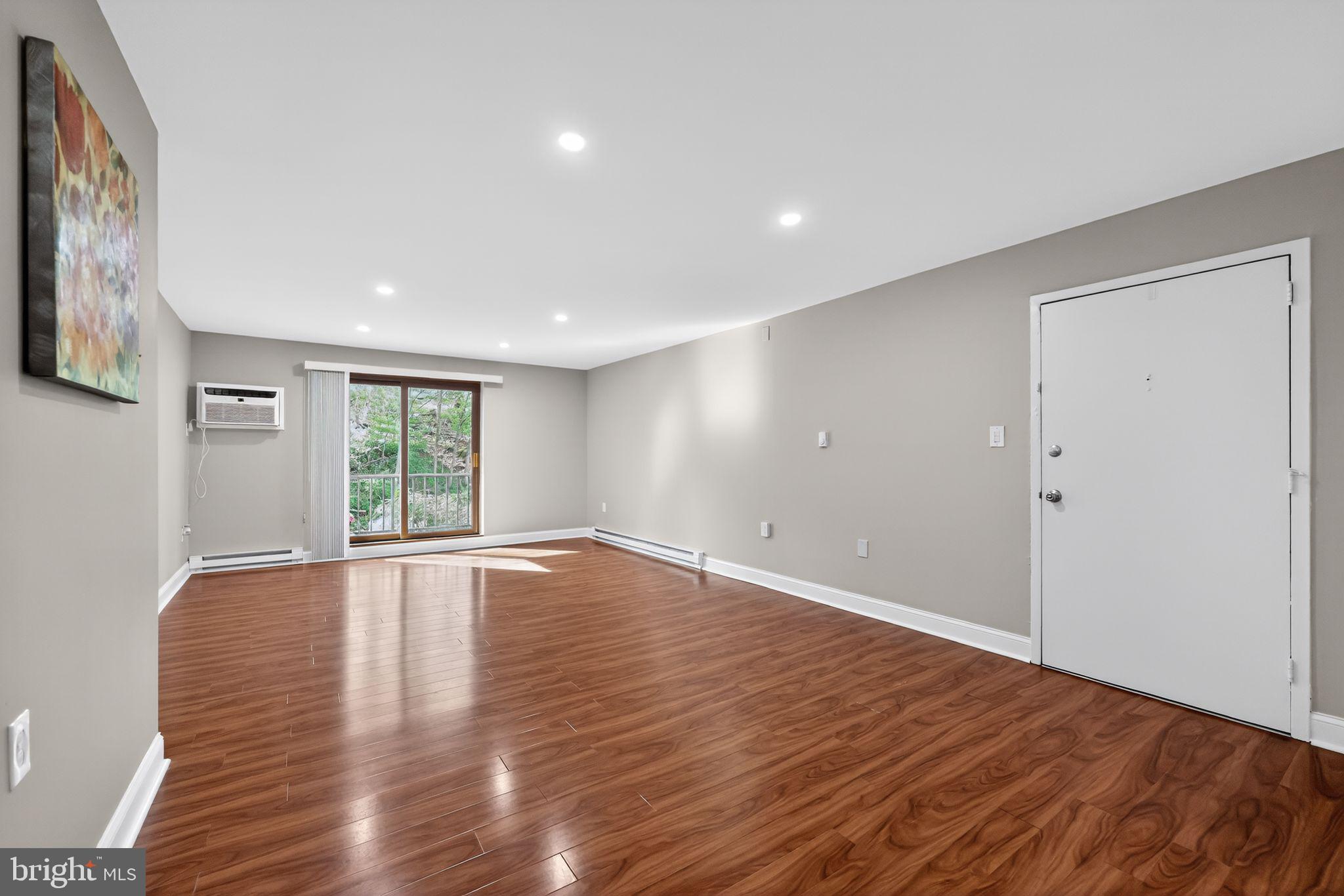 400 Glendale Road, Unit F35 Havertown, PA 19083 - Photo 6 of 36 a view of an empty room with wooden floor and a window