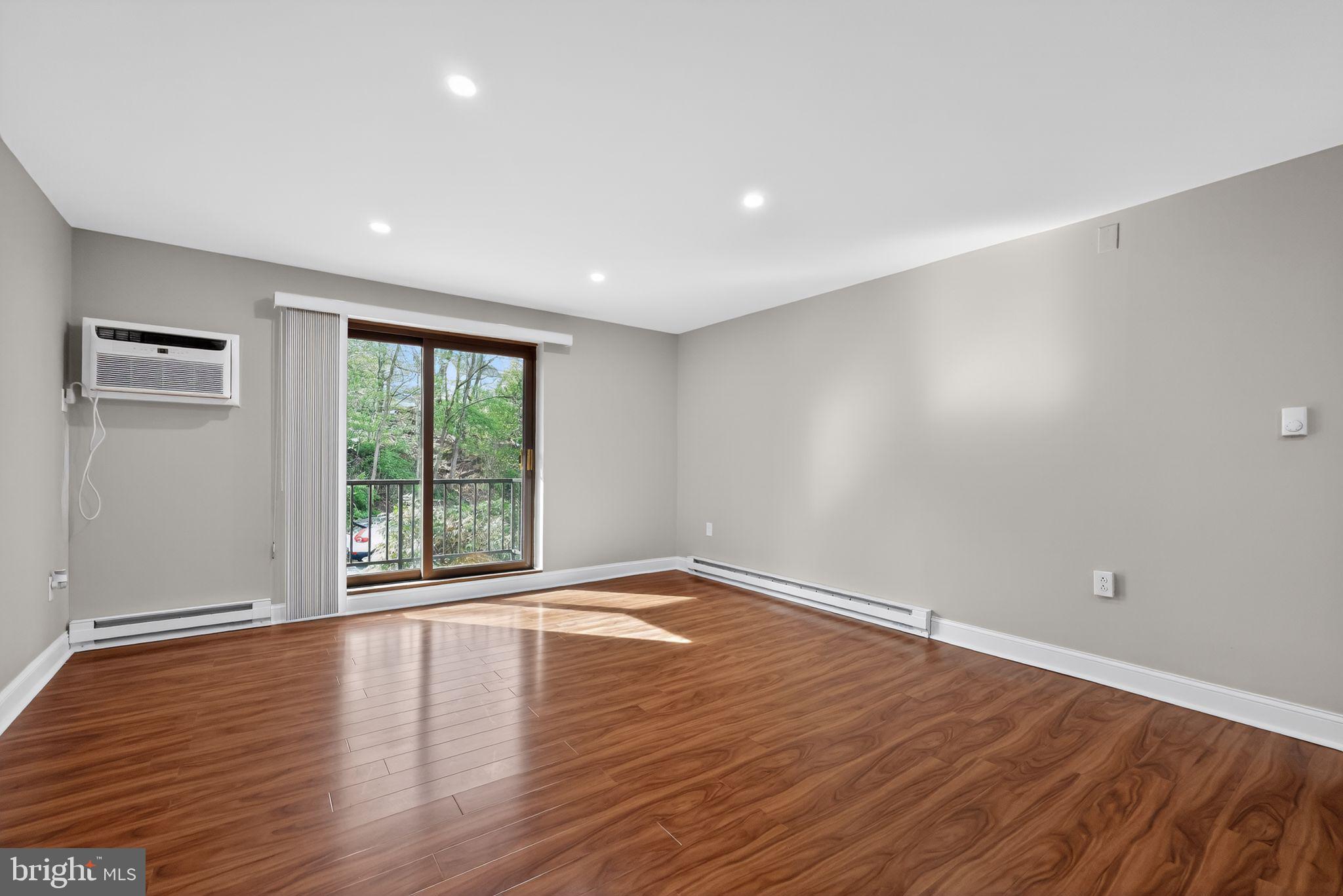 400 Glendale Road, Unit F35 Havertown, PA 19083 - Photo 8 of 36 a view of an empty room with wooden floor and a window