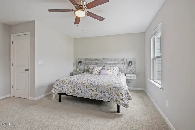 a bedroom with a bed and a window