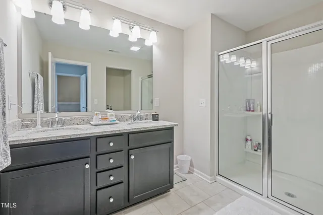 a bedroom with a bed and a lamp