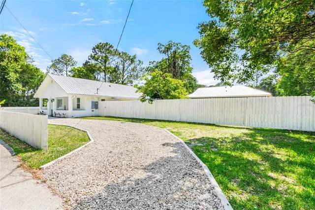 a bathroom with a sink and a yard with green space