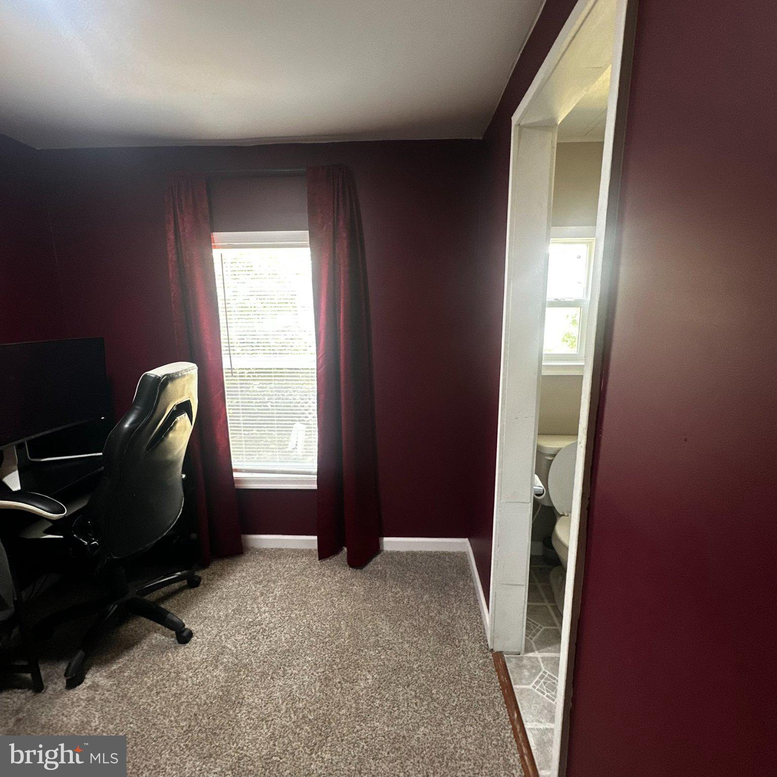 31777 Siham Road Lewes, DE 19958 - Photo 10 of 46 Cozy workspace with rich burgundy walls.