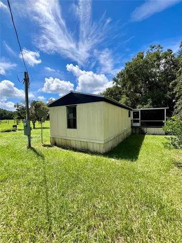 a backyard of a house with lots of green space