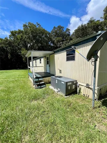 a view of a backyard with a garden and entertaining space