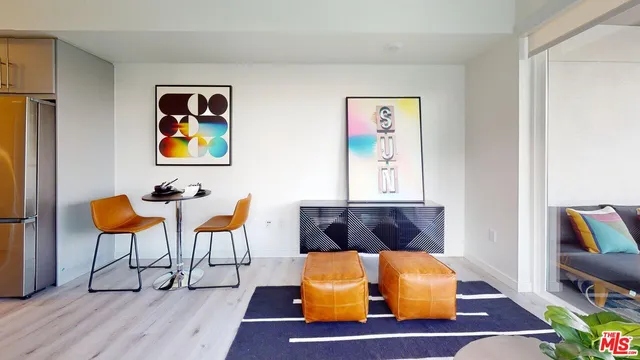 a living room with blue wall paintings and a lamp