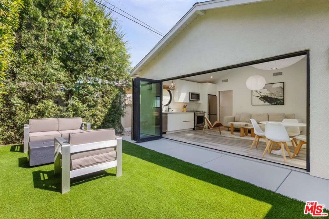 a patio with yard table and chairs
