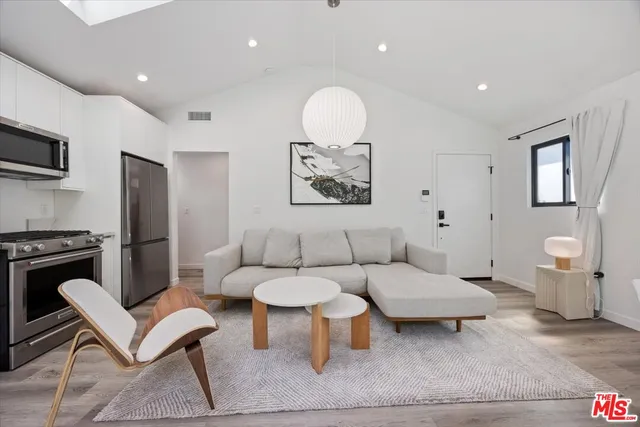 a living room with furniture a rug and a fireplace