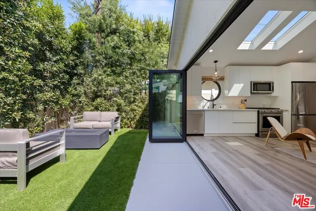 a backyard of a house with table and chairs
