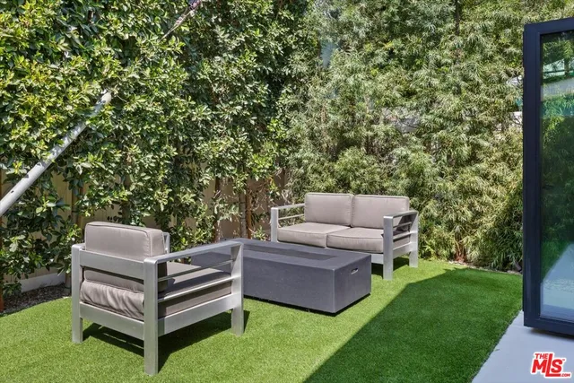 a kitchen with stainless steel appliances a refrigerator sink and microwave