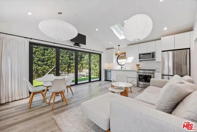 a living room with couch a table and a large window