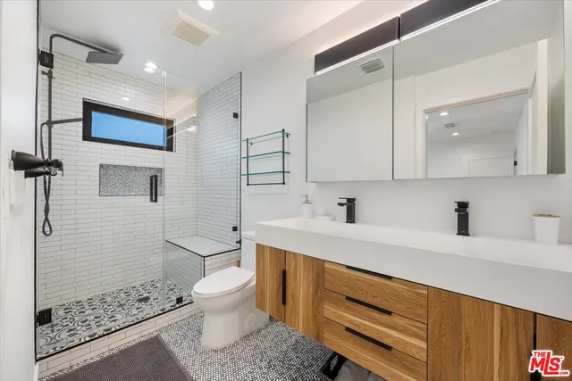 a bathroom with a sink a mirror and a toilet