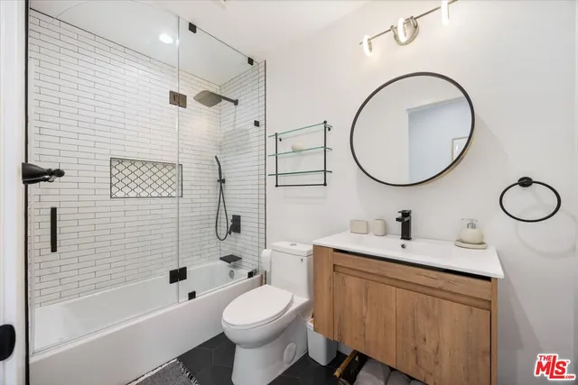 a bathroom with a toilet a sink and a mirror