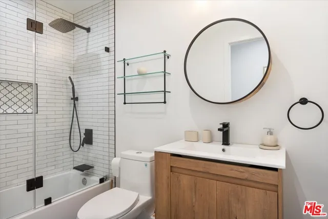 a hallway with closet and wooden floor