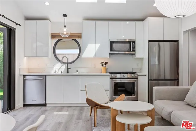 a kitchen with a sink stove and refrigerator